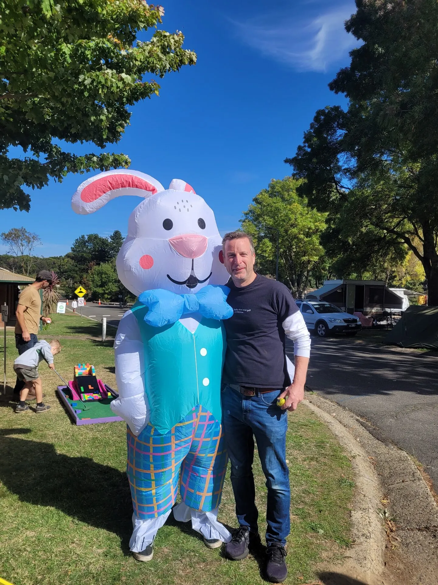 Steve, founder of Lucky Shot Mini Golf, with the giant Easter bunny at a community event